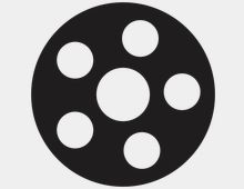 Black circular film reel icon with five evenly spaced round holes around a larger central hole on a white background.